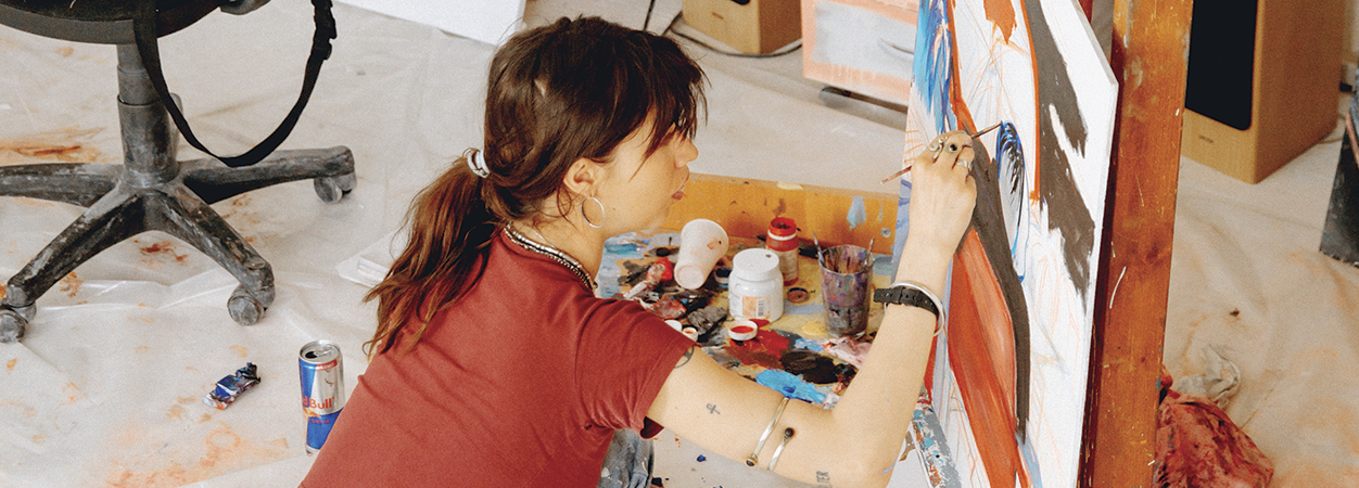 An art student painting in class.