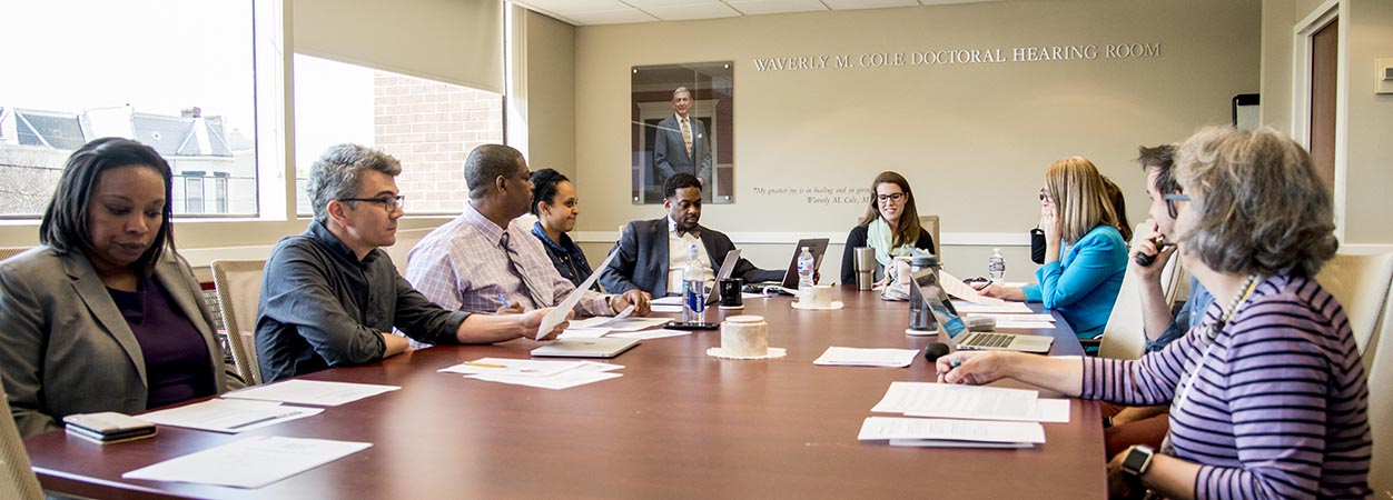 A group of School of Education alumni having a discussion during an Education Alumni Council meeting.