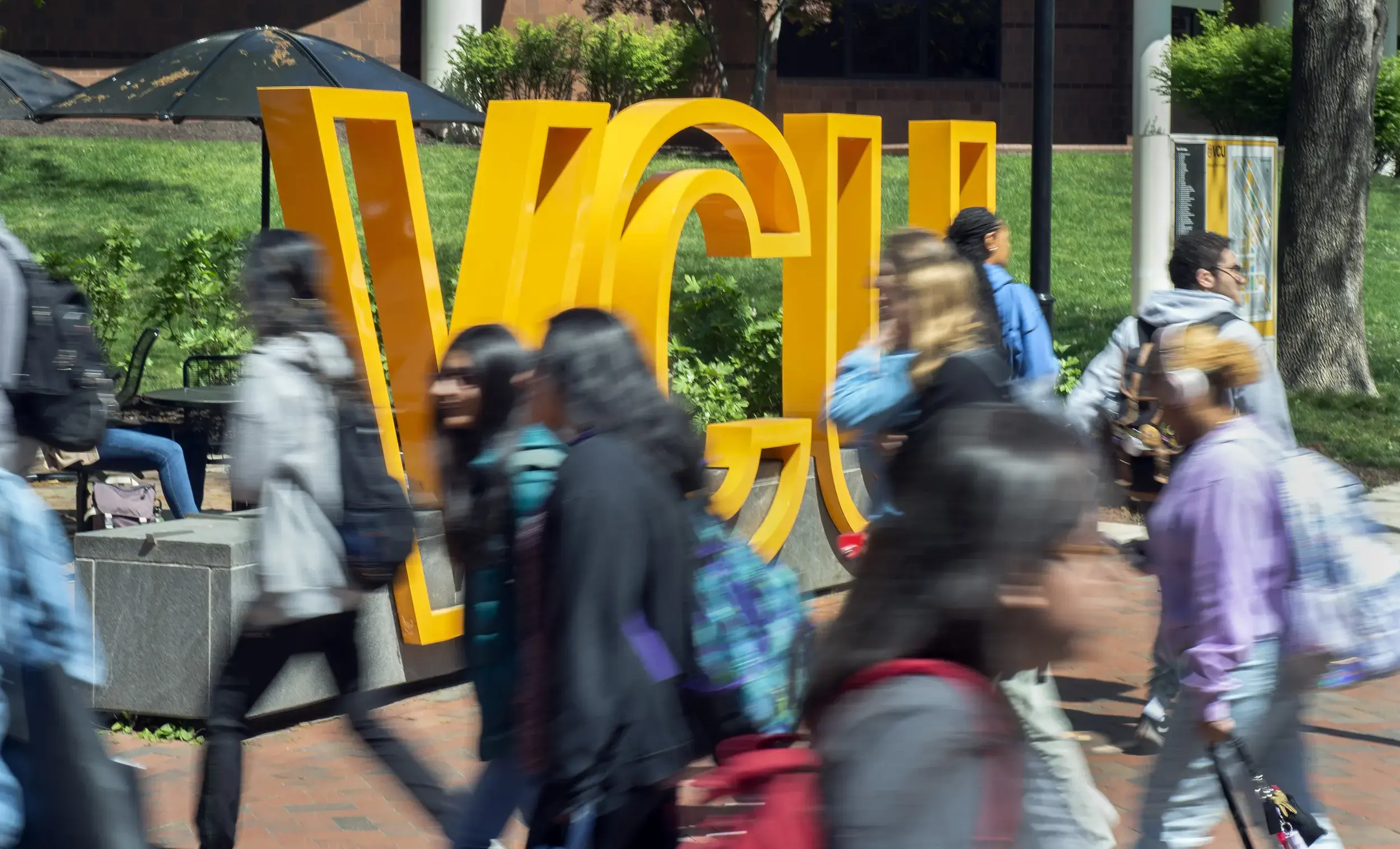 Students walking past VCU sculpture