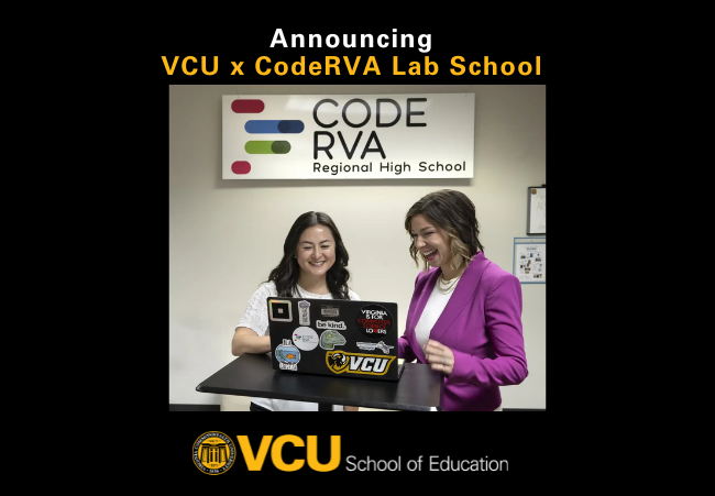 Two School leaders at a laptop with CodeRVA sign in backgroun