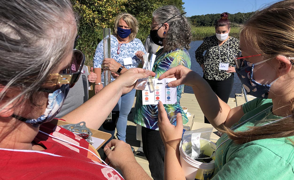 In the foreground, teachers tested for nitrates while SOE's Elizabeth Edmondson, Ph.D., tested the river water for turbidity in the background. (Courtesy photo)