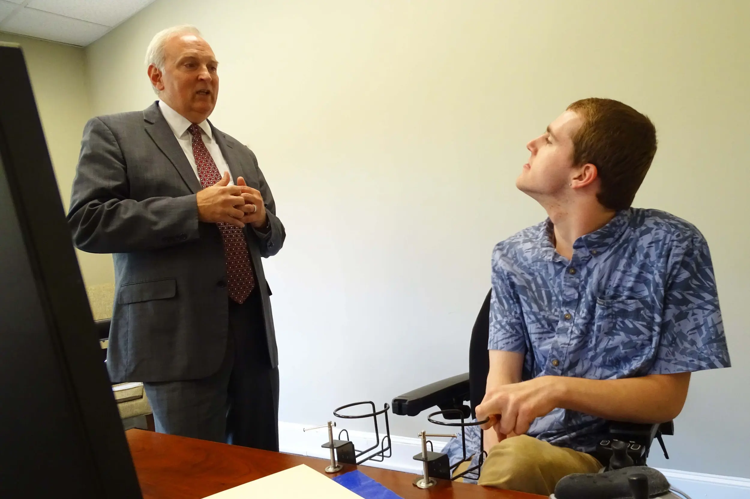 Attorney Matt Bellinger, owner of BeneCounsel, discusses work tasks with Lowery. Bellinger hired Lowery in 2023 as he expanded his law firm operations. (Photo by Lucian Friel)